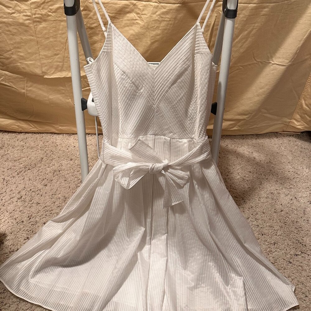 Off-white ruffled style dress with strips and V neck, and same fabric belt